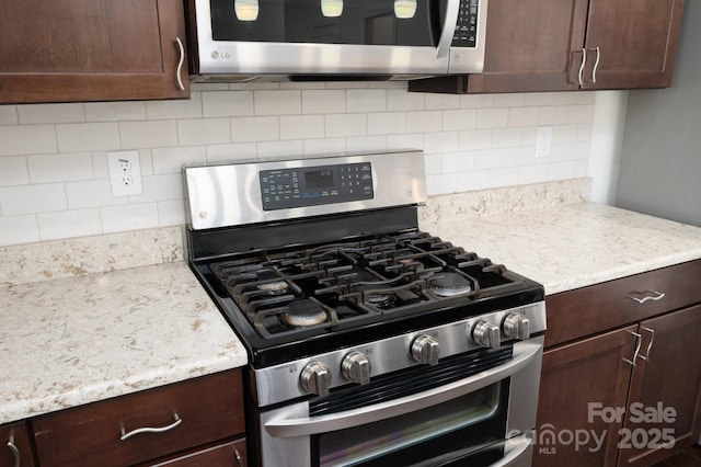 kitchen featuring decorative backsplash, dark brown cabinets, and stainless steel appliances