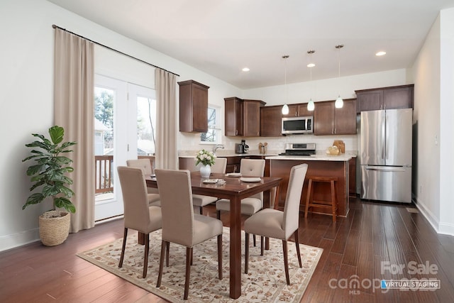 dining space with dark hardwood / wood-style floors