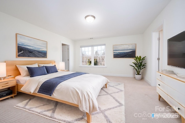 bedroom featuring light carpet