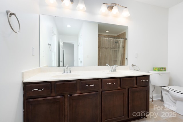 bathroom featuring toilet, vanity, tile patterned flooring, and a shower with shower curtain