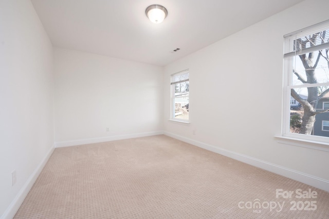 carpeted empty room with a wealth of natural light