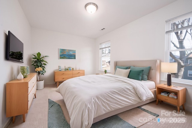 bedroom featuring light colored carpet