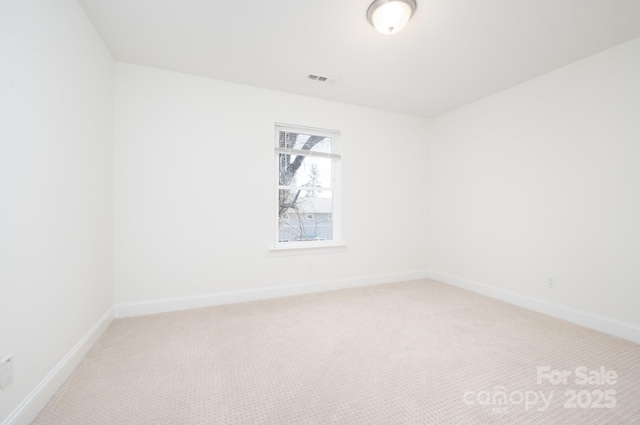 unfurnished room featuring carpet