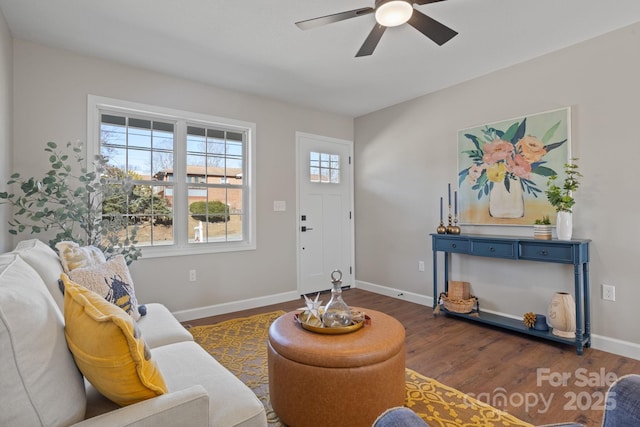 living room with ceiling fan and dark wood-type flooring