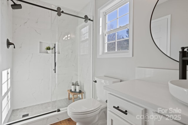 bathroom featuring wood-type flooring, vanity, toilet, and walk in shower