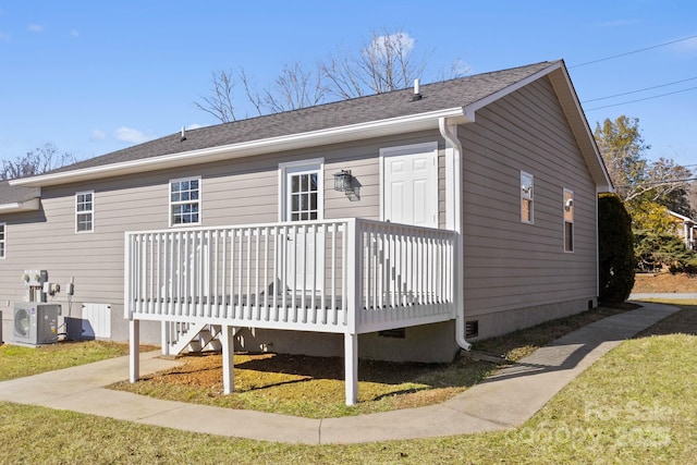 back of house featuring ac unit and a wooden deck