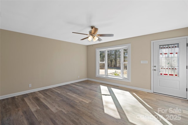 empty room with dark hardwood / wood-style flooring and ceiling fan