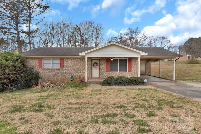 single story home with driveway, an attached carport, a front lawn, and brick siding