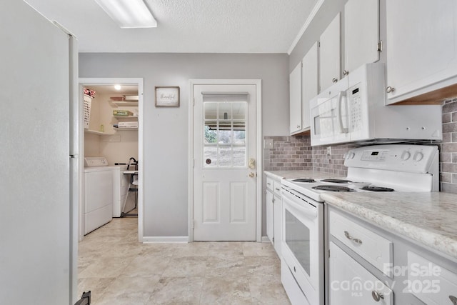 kitchen featuring white appliances, decorative backsplash, light countertops, white cabinetry, and separate washer and dryer