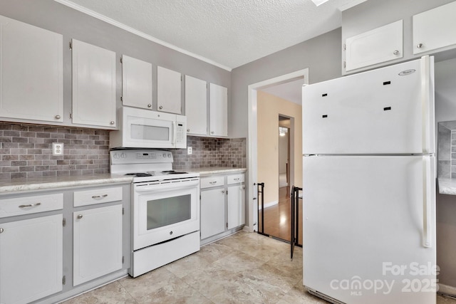 kitchen with white appliances, tasteful backsplash, light countertops, a textured ceiling, and white cabinetry