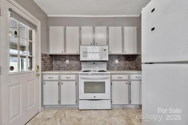 kitchen with a textured ceiling, white appliances, light countertops, ornamental molding, and decorative backsplash