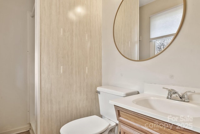 bathroom featuring vanity and toilet