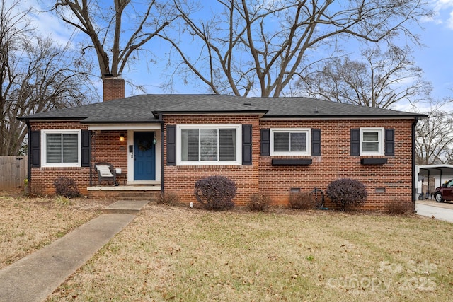 view of front of home with a front lawn and a carport