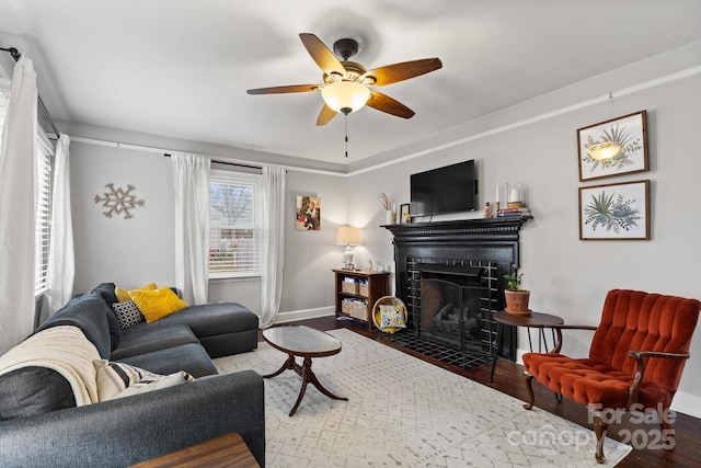 living room featuring ceiling fan and hardwood / wood-style flooring