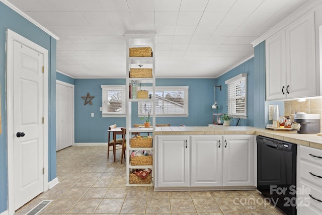 kitchen with kitchen peninsula, crown molding, white cabinets, and black dishwasher