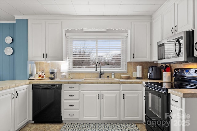 kitchen with sink, white cabinetry, and black appliances