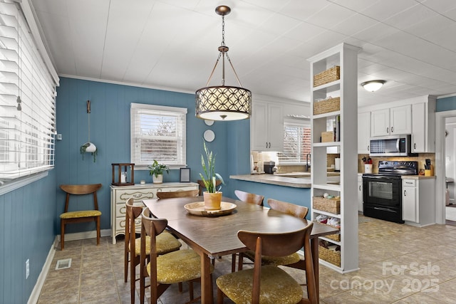 dining space featuring crown molding