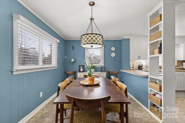 tiled dining space featuring ornamental molding