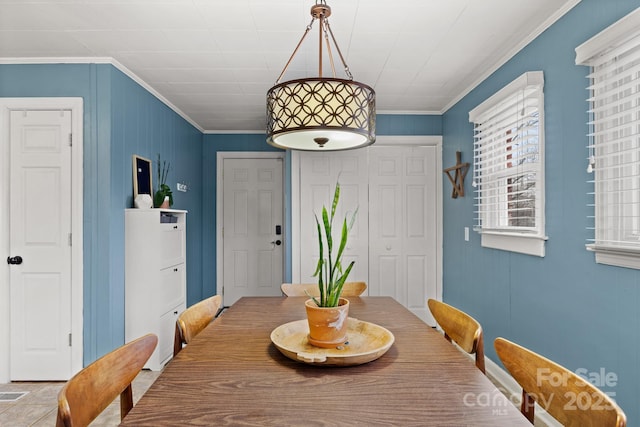 dining room featuring crown molding and a wealth of natural light