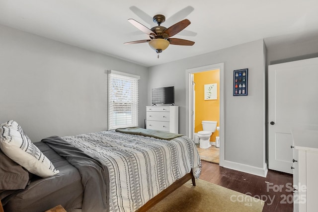 bedroom featuring ceiling fan, dark hardwood / wood-style floors, and connected bathroom