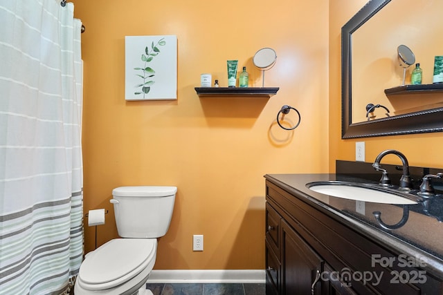 bathroom with tile patterned floors, vanity, and toilet