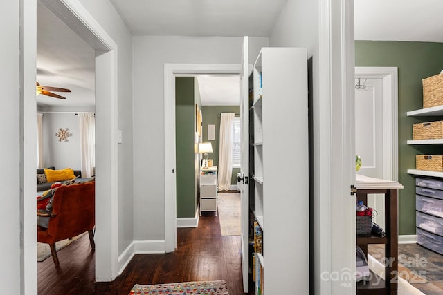 corridor with dark hardwood / wood-style flooring