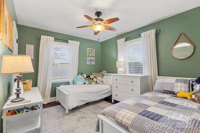 bedroom featuring multiple windows and ceiling fan