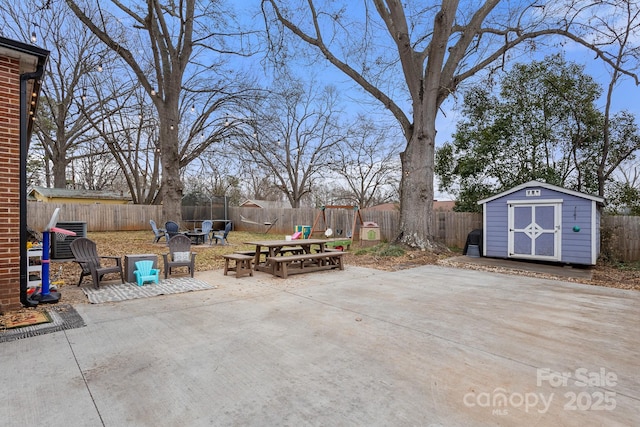 view of patio / terrace featuring an outdoor fire pit and a storage shed