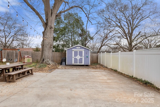 view of patio / terrace with a playground and a shed