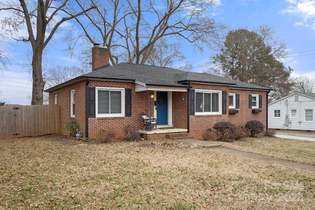 bungalow-style house featuring a front lawn