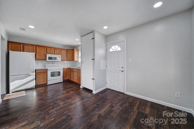 kitchen featuring decorative backsplash, white appliances, and dark wood-type flooring