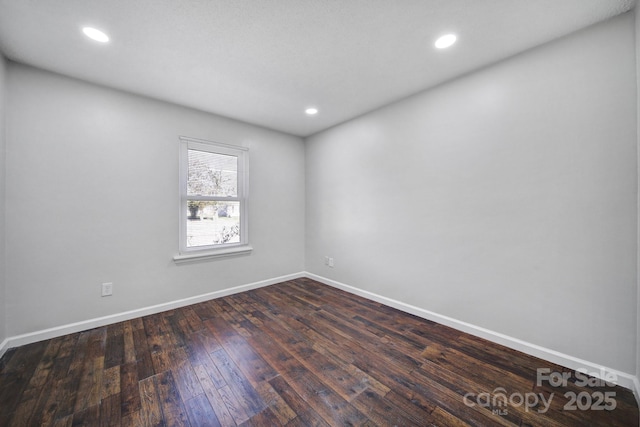 empty room with dark wood-type flooring