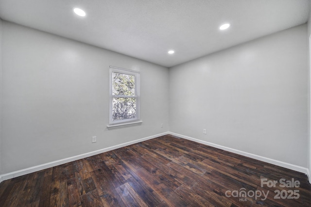 unfurnished room featuring dark wood-type flooring