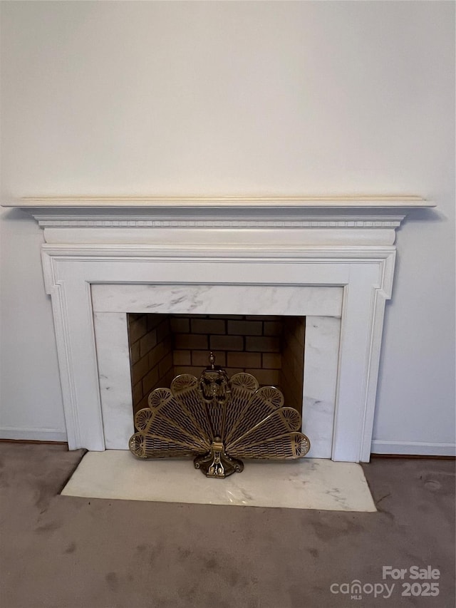 room details with a fireplace and carpet floors