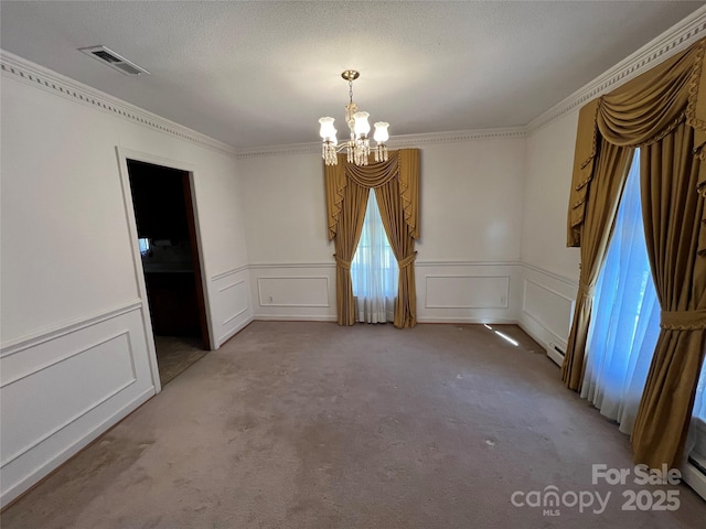 unfurnished dining area with crown molding, carpet, and a chandelier