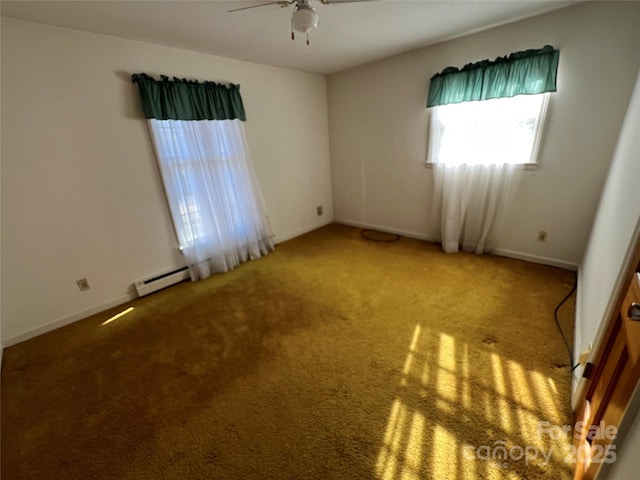 carpeted spare room featuring ceiling fan and a baseboard radiator