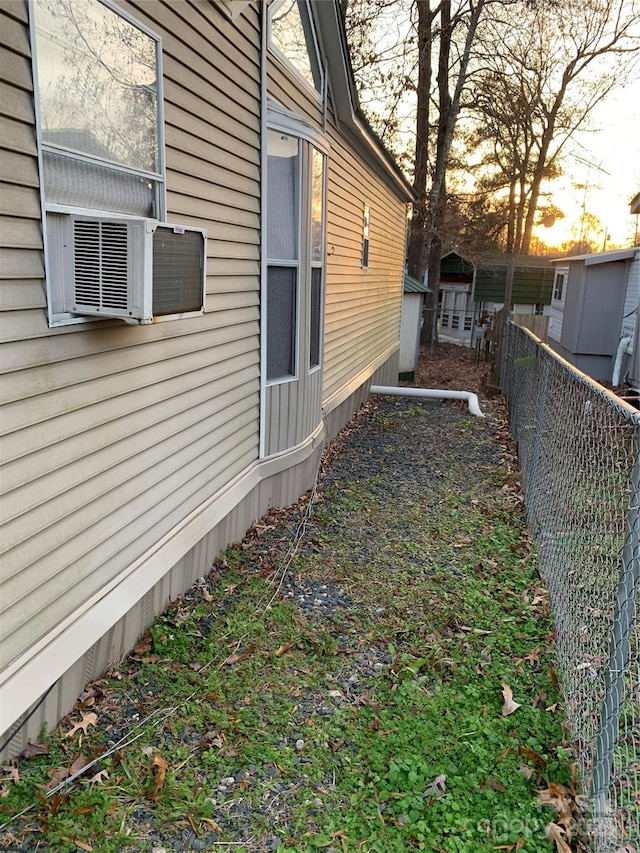 property exterior at dusk featuring cooling unit