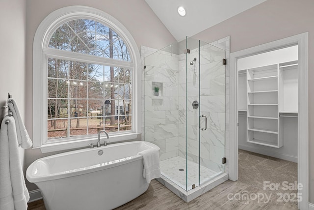 bathroom featuring lofted ceiling and independent shower and bath