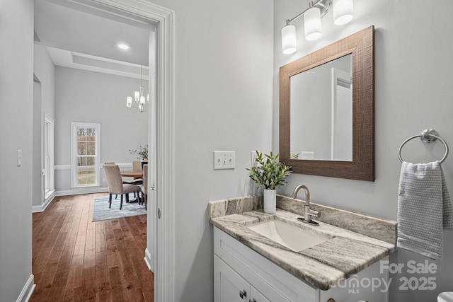 bathroom with hardwood / wood-style floors and vanity