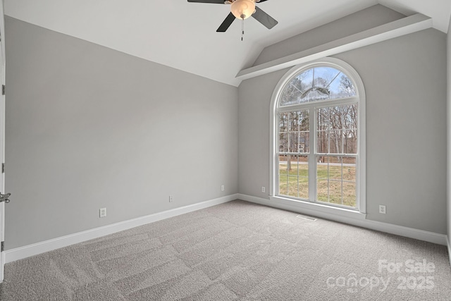 unfurnished room featuring ceiling fan, light colored carpet, lofted ceiling, and plenty of natural light