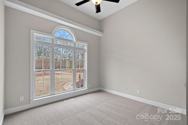 empty room featuring carpet floors and ceiling fan