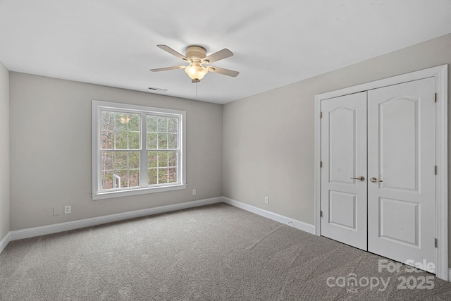 unfurnished bedroom featuring ceiling fan, a closet, and carpet floors