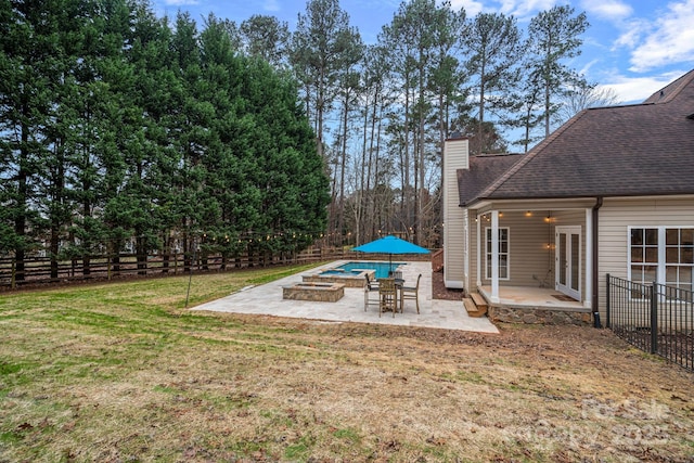 view of yard featuring a fenced in pool, french doors, and a patio