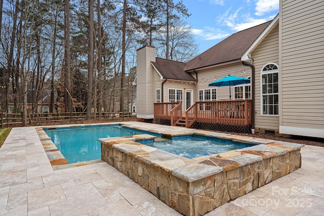 view of pool featuring a deck, an in ground hot tub, and a patio