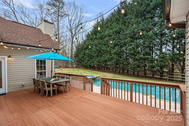 deck featuring a fenced in pool