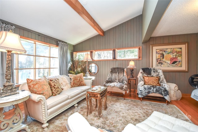 living room with wooden walls, hardwood / wood-style floors, and lofted ceiling with beams