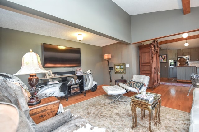 living room featuring hardwood / wood-style floors and beamed ceiling