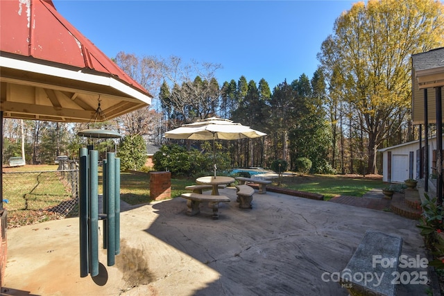 view of patio with an outbuilding