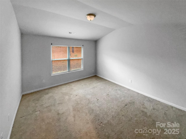 spare room featuring vaulted ceiling