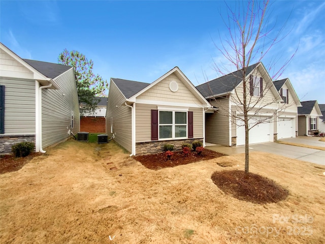 view of front of property with central AC unit and a garage